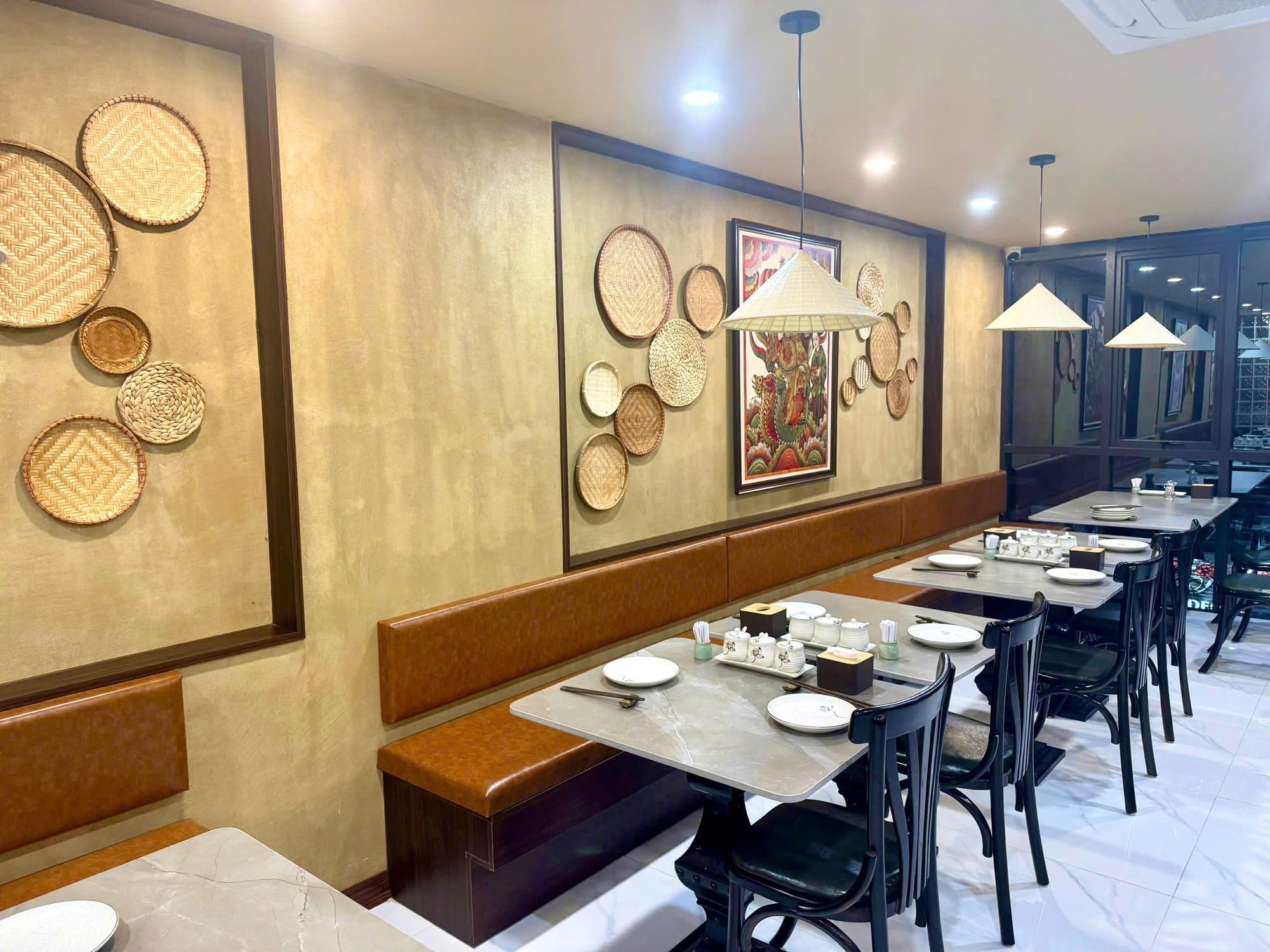 Bánh Xèo Nón Lá dining room with woven basket decor and leather booth seating